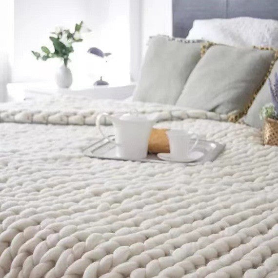 Person resting under chunky knit weighted blanket for sensory comfort and better sleep